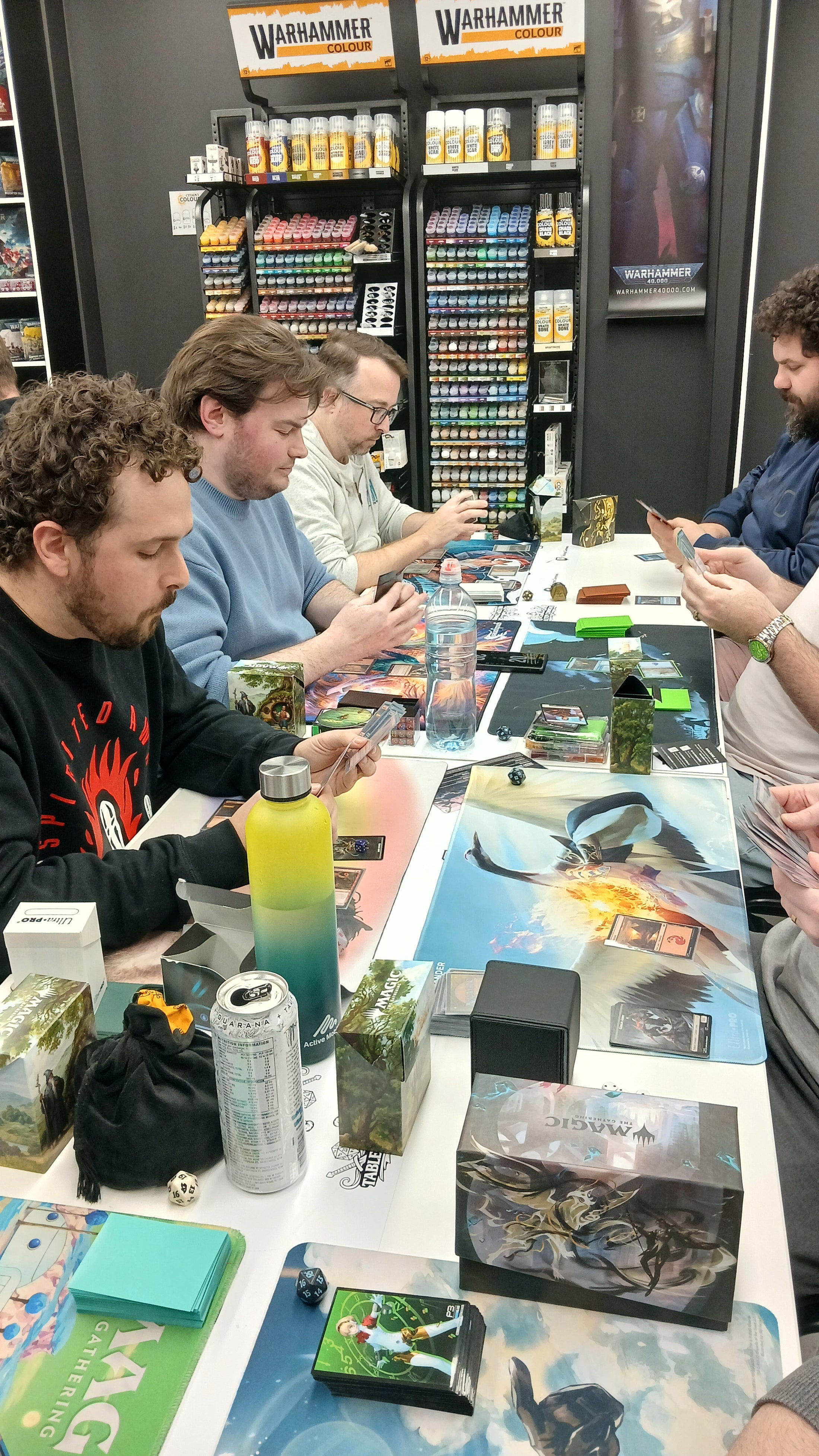 Magic: The Gathering players sharing a game at Tabletop Commons in Warrawong